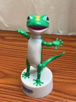 Full view of GEICO gecko figure on base