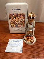 Front view of figurine with box and certificate