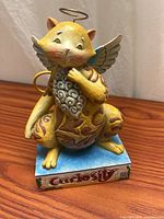 Full view of Jim Shore cat angel figurine on base
