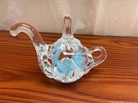Full view of clear glass teapot ring holder showing overall shape