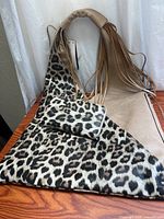Leopard print purse laid flat with wallet on top