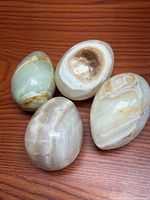 Four onyx eggs grouped on wooden surface