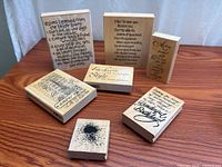All seven wood-mounted stamps displayed on tabletop