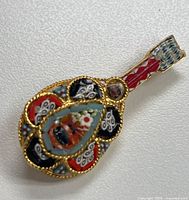 Front view showing mosaic design and gold-tone filigree