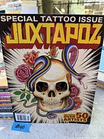 Front cover of special tattoo issue with skull, roses, snake