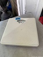 Top view of beige Conselor analog bathroom scale showing textured surface and dial window
