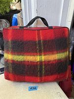 Front of plaid cushion case with handle