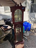 Full view of Colson wooden grandmother clock showing case, door, and lower section