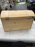 Front view of pine chest showing dovetail joints and dome lid