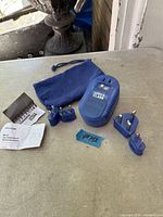 Converter, four plug adapters, pouch, manual, warranty card visible