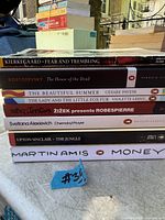 Stacked view of all eight paperback book spines showing titles and authors