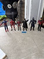 Frontal view of all six action figures lined up on tabletop