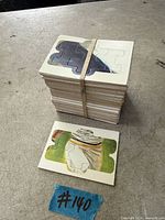 Stack of Diamond King puzzle card panels bound with rubber band; one panel front displayed showing puzzle artwork