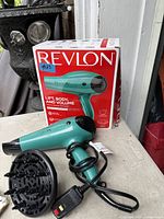 Hair dryer, diffuser and box displayed together