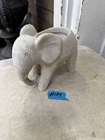 Front side view of cement elephant planter