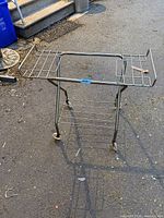 Full view of metal trolley cart with expandable top and lower rack