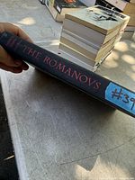 Spine view of hardcover book "The Romanovs" showing cloth cover and title lettering