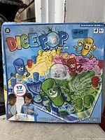Front of Dice Pop Race Game box showing graphics, pop dice feature, 17 pieces info