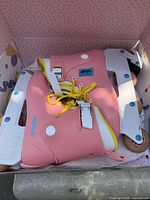 Pair of pink Impala inline skates in box