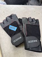 Top view of both GoZone fingerless gloves showing branding, materials and overall condition