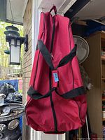 Full view of red rolling duffle bag hanging vertically
