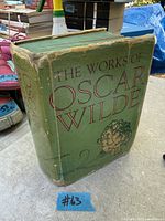 Front view of large green hardcover book showing title and wear