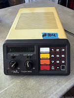 Front view showing keypad, display, controls and branding