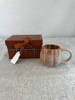 Mug beside closed gift box