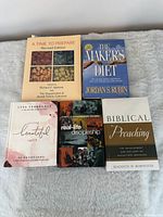 All five books laid out showing fronts