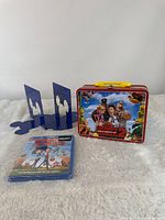 All three items grouped: Blu-ray, lunchbox, bookends