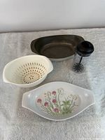 Group shot showing all four items: Shafford dish, metal baker, plastic bowl with colander, French press