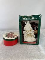 Porcelain Santa in box beside nested boxes