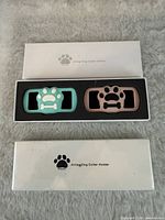 Both teal and rose holders seated in foam inside branded box