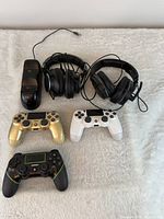 Full lot: three controllers, two headsets, charging dock displayed on surface