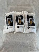 Three sealed ZeroWater replacement filter pouches laid side by side