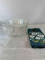 Punch bowl next to folded floral towels