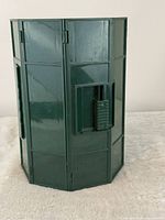 Closed green RolyKit showing hexagonal panels, latch and handle