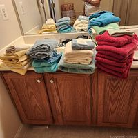Stacked assorted towels on vanity