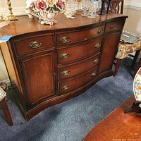 Front view of dark brown Bassett buffet with drawers and cabinet doors