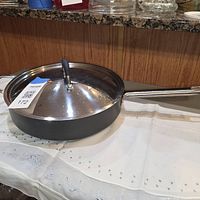 Side view of 10-inch pan with lid on handle side visible