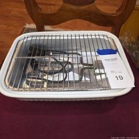 top view of roaster with interior insert, rack, cord, and heating element visible