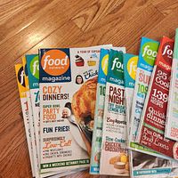 Front covers of several stacked Food Network Magazine issues showing variety of cover designs