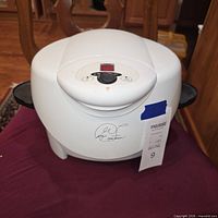 Closed George Foreman white electric grill showing digital control panel and logo