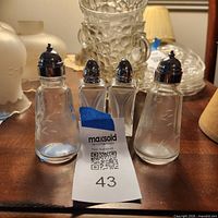 Front view of all four shakers on tabletop