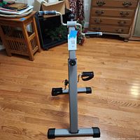 Front view showing full pedal exerciser setup with frame, handle and pedals