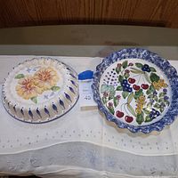 Front view of both pie plates showing designs and scalloped rims