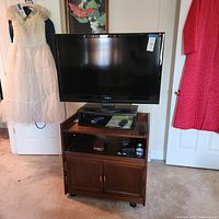 Full view of Insignia TV on wooden cabinet