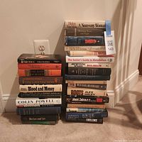 Two stacks of hardcover books showing spines and titles