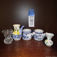 Front view of five miniature vases showing materials, colors, designs, and condition.