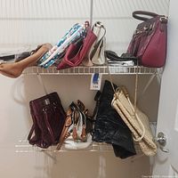 Overall view of shelf with multiple bags showing quantity, colours and types